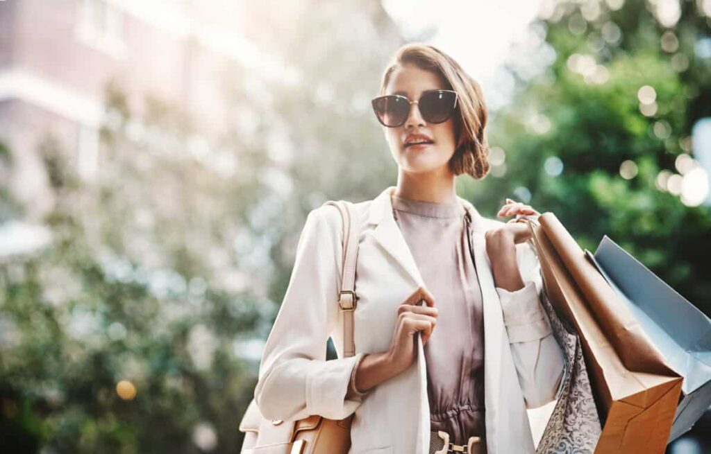 1 TSX Consumer Stock That Could Bounce Back Fast shopper carries paper bags with purchases