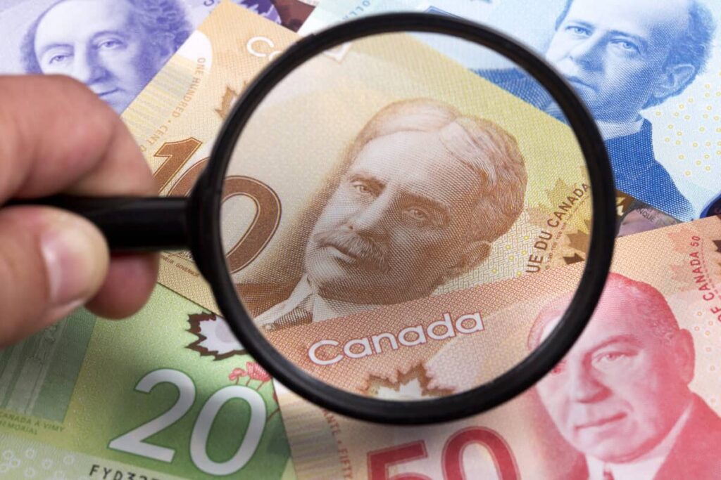 A Simple Way for Canadians to Earn $500 a Month Tax-Free From a TFSA Canadian dollars in a magnifying glass
