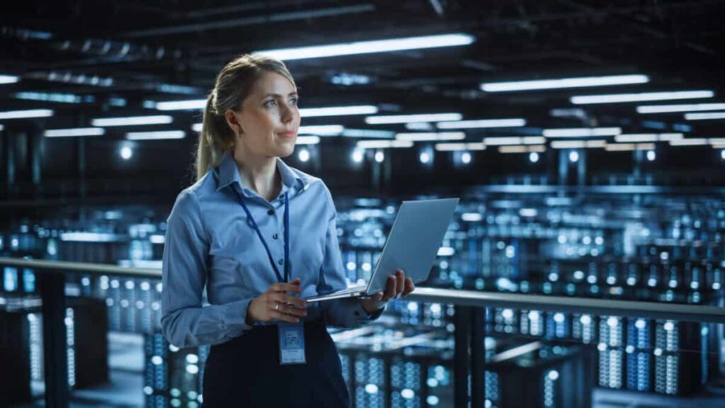 1 Canadian Company Set to Profit From the $650 Billion Data Centre Buildout Data center woman holding laptop