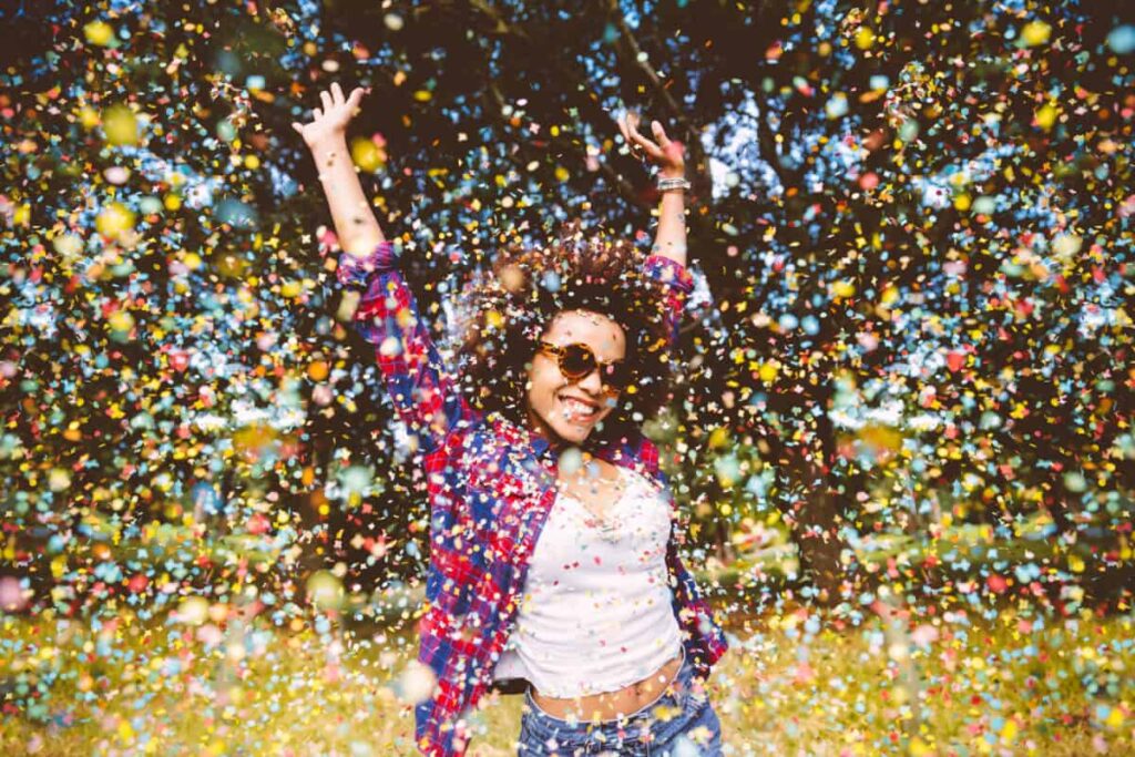 Hot Take: Here Are 2 of the Best Canadian Stocks to Buy and Hold in a TFSA person enjoys shower of confetti outside